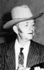 David Marshall Williams wearing a hat and suit.