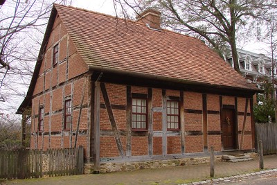 A red tutor home with a chimney in Old Salem.