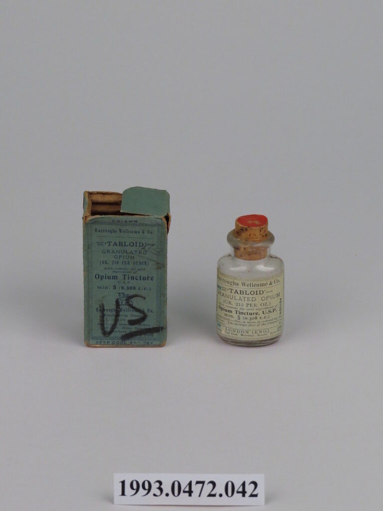 A small bottle of opium tincture next to its box.