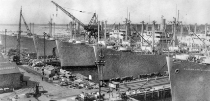 Ships lined up at outfitting piers of the North Carolina Shipbuilding Company in Wilmington. North Carolina Collection, University of North Carolina at Chapel Hill Library.