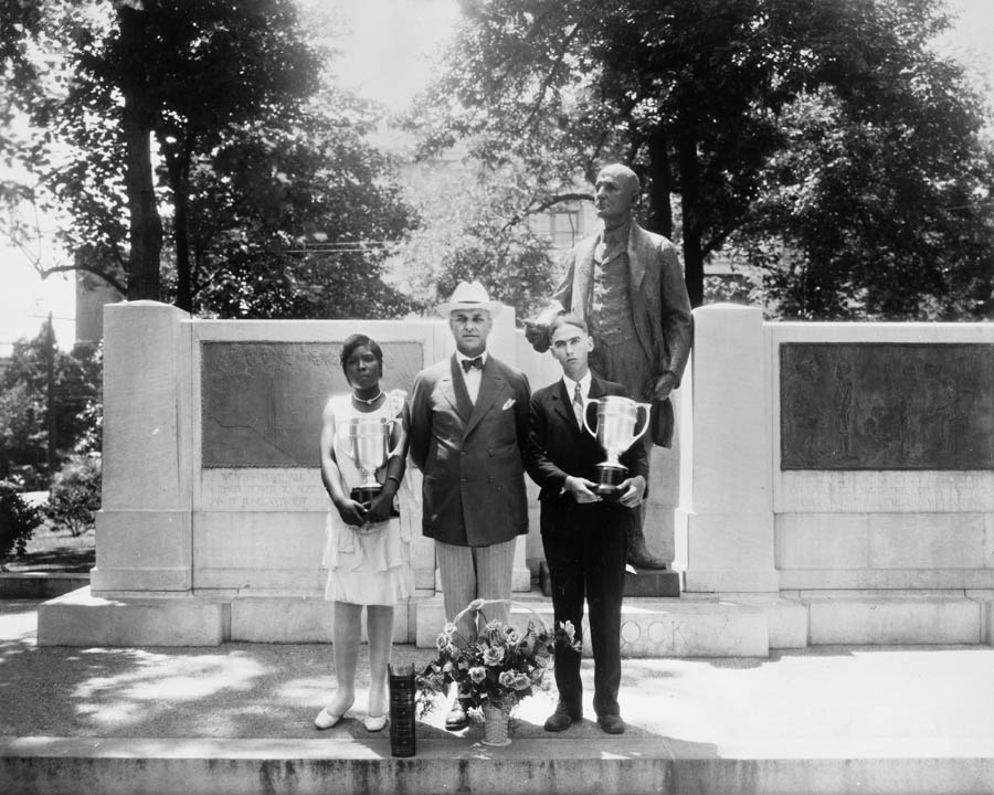 Winners of the high school Live-at-Home essay contest, Ophelia Holley and Leroy Sossamon, pose with Governor O. Max Gardner, June 23, 1930.