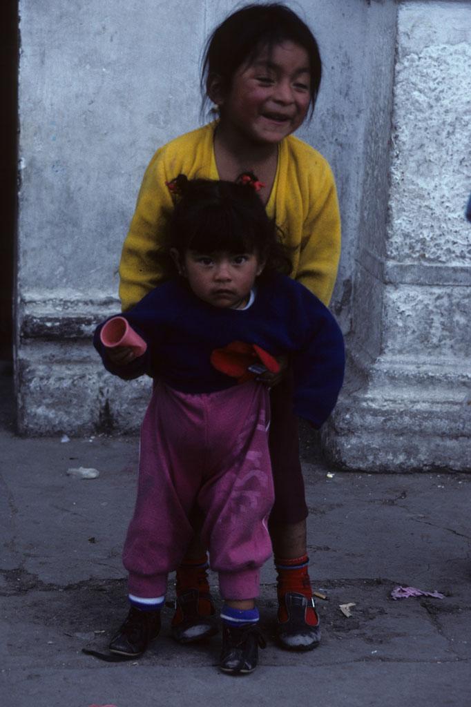 Two children play on the sidewalk in Latacunga, Ecuador | NCpedia