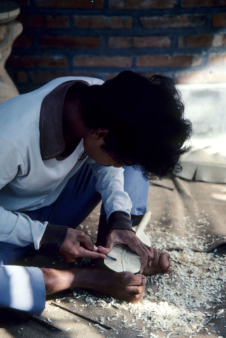 Balinese woodcarver finishing leaf