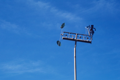 Balinese weathervane and windchime posted on pole