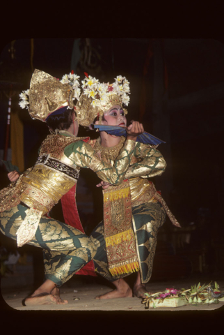 Two girls performing welcome dance engage each other in mirror image pose