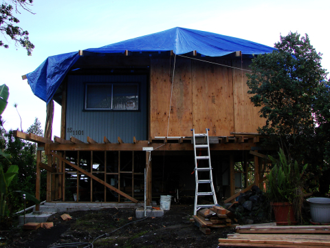 Home damaged by earthquake and heavy rain