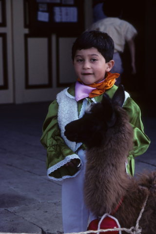 Child with a llama in Riobamba, Ecuador