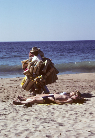 Selling baskets on the beach at Puerto Vallarta, Mexico