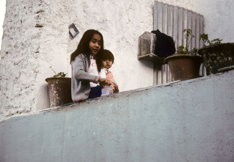 Two children play on a rooftop in Guanajuato, Mexico