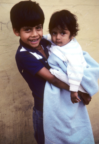 A young boy holds a small child in Guanajuato, Mexico