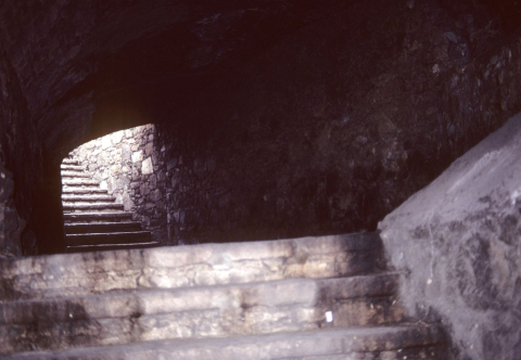 Steep stone stairs lead up to the light