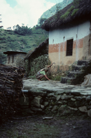 Woman coloring house in Nepal