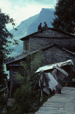 Nepalese men roofing a house