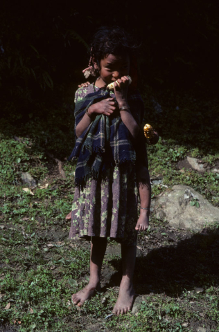 Nepalese girl with infant on her back