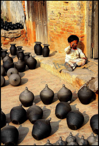 Child and pottery in Nepal