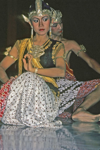 Sita and Rama dancers kneel close together at Ramayana performance in Yogyakarta