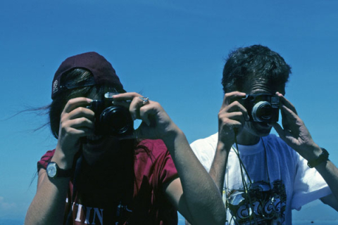 Two tourists take photographs near Nha Trang