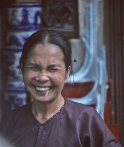 Hanoi woman laughing with toothpick in her mouth