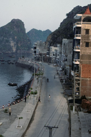 Elevated vew of buildings and quiet street along Cat Ba harbor waterfront