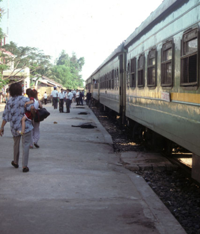 Passengers walking outside train on platform between Hanoi and Dong Ha