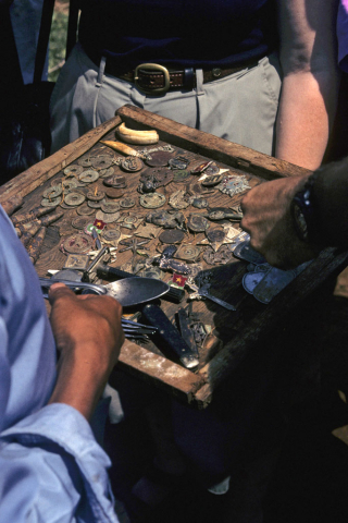 Tray filled with military badges and other artifacts from the Vietnam wars