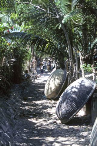 Two round basket boats dry in an alley near Nha Trang