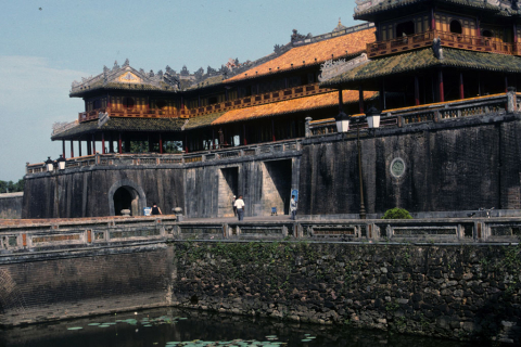 Noontime Gate or main entrance over moat into walled Imperial City at Hue