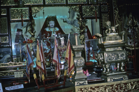 Figurines and flags on gilded shrine used by Fukian Chinese at Hoi An