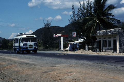 Bus and commercial building on main road between Nha Trang and Dalat