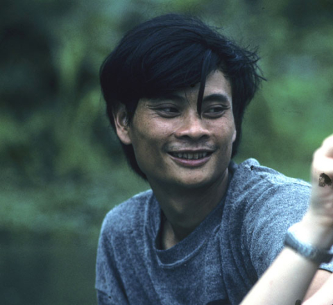 Portrait of smiling young man with forelock at Hoa Lu