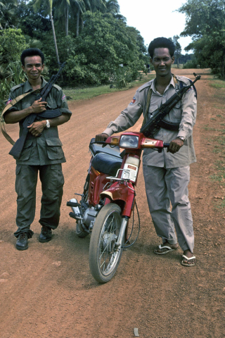 Two guards with machine guns who escort tourists to Banteay Srei Temple