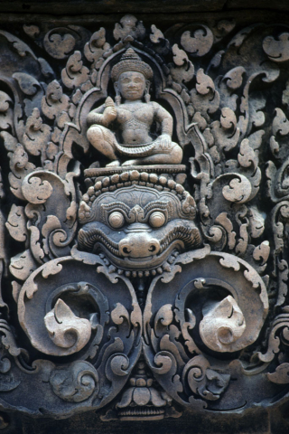 Guardian deity above monster on low relief carving at Banteay Srei Temple