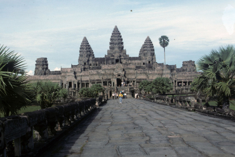 View from causeway into Angkor Wat with tiers rising to five central towers