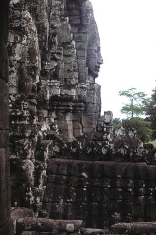 Bayon Temple tower wall with carved stone faces in profile at Angkor Thom