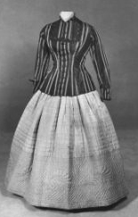 Two piece, brown and beige striped corded taffeta jacket with tortoise shell buttons in floral motif; hand-quiltedbeige taffeta skirt (petticoat), circa 1865. Available from the North Carolina Museum of History. 